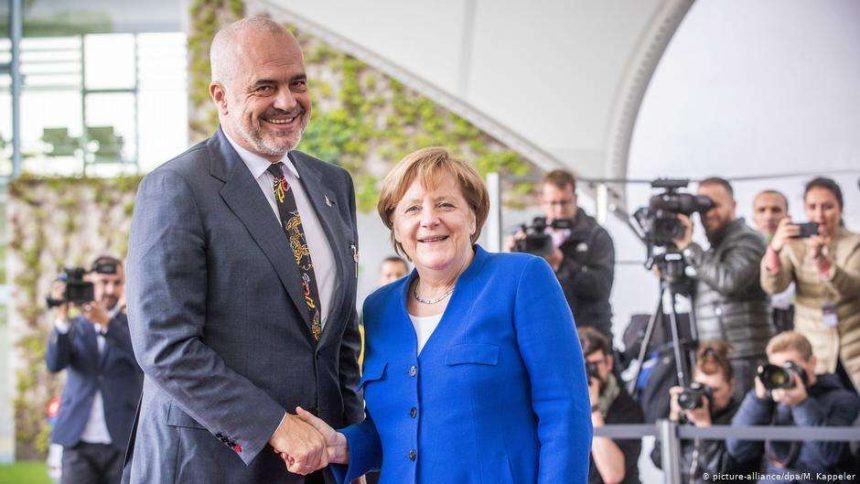 rama-merkel-handshake.jpg